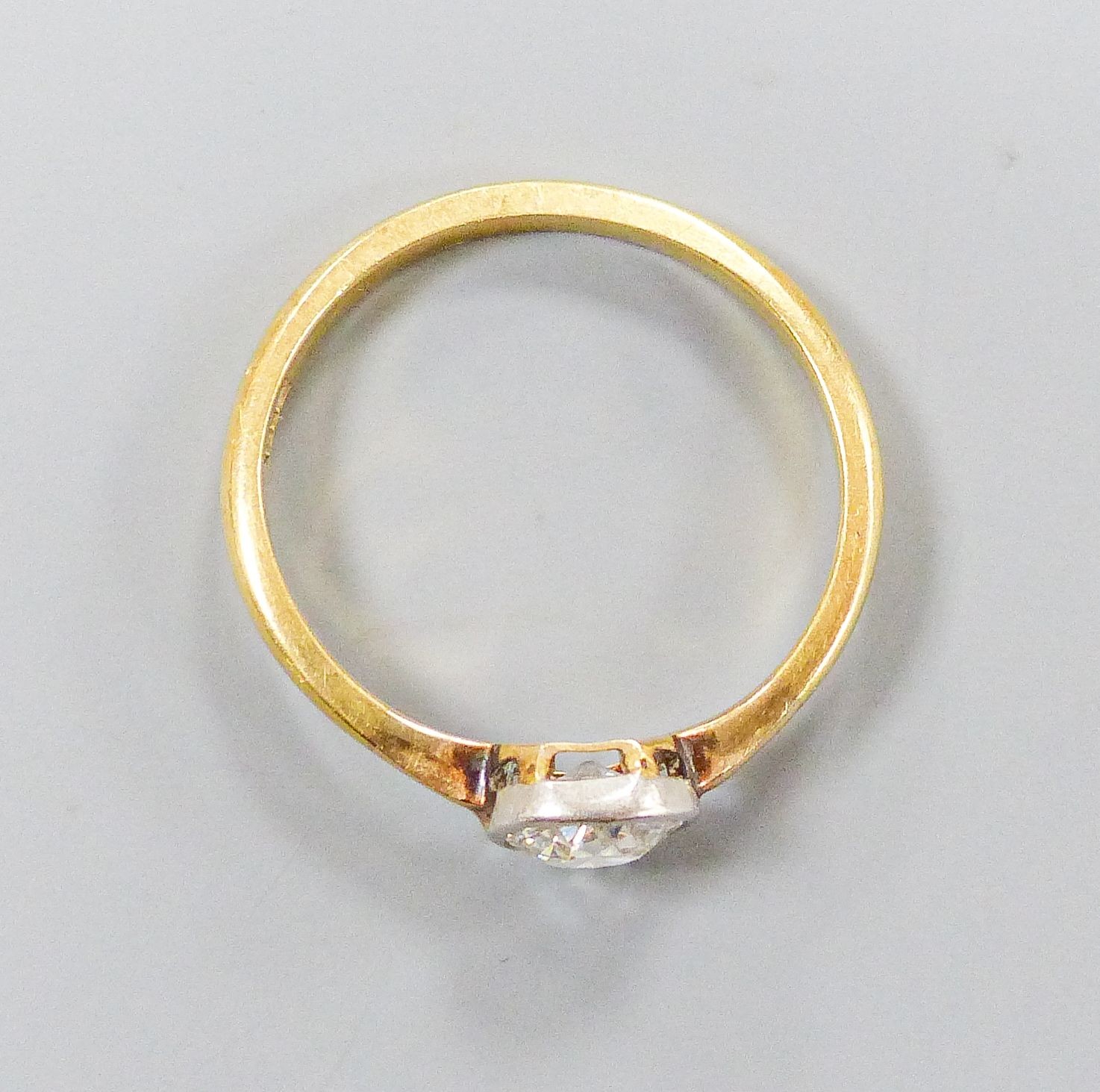 An 18ct and collet set solitaire diamond ring, size M, gross weight 2.3 grams